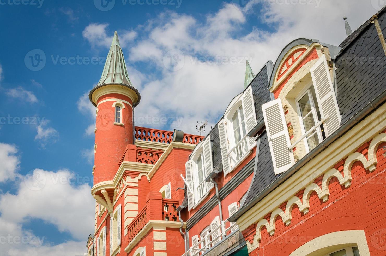 Small red tower on building with white shutters photo