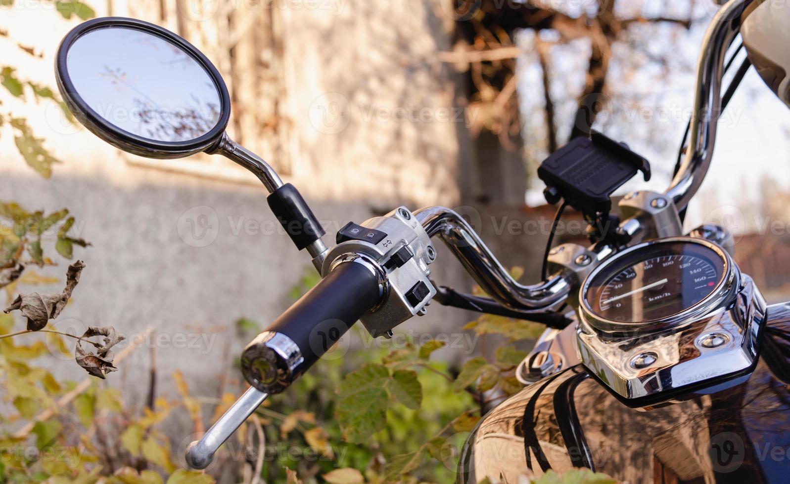 handlebar and speedometer of classic chopper motorcycle close up photo