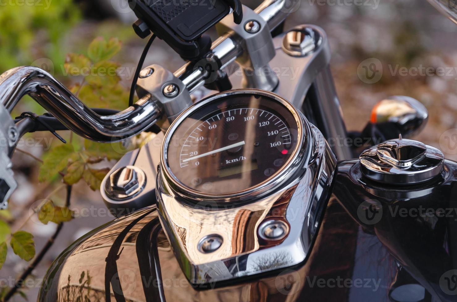 handlebar and speedometer of classic chopper motorcycle close up photo