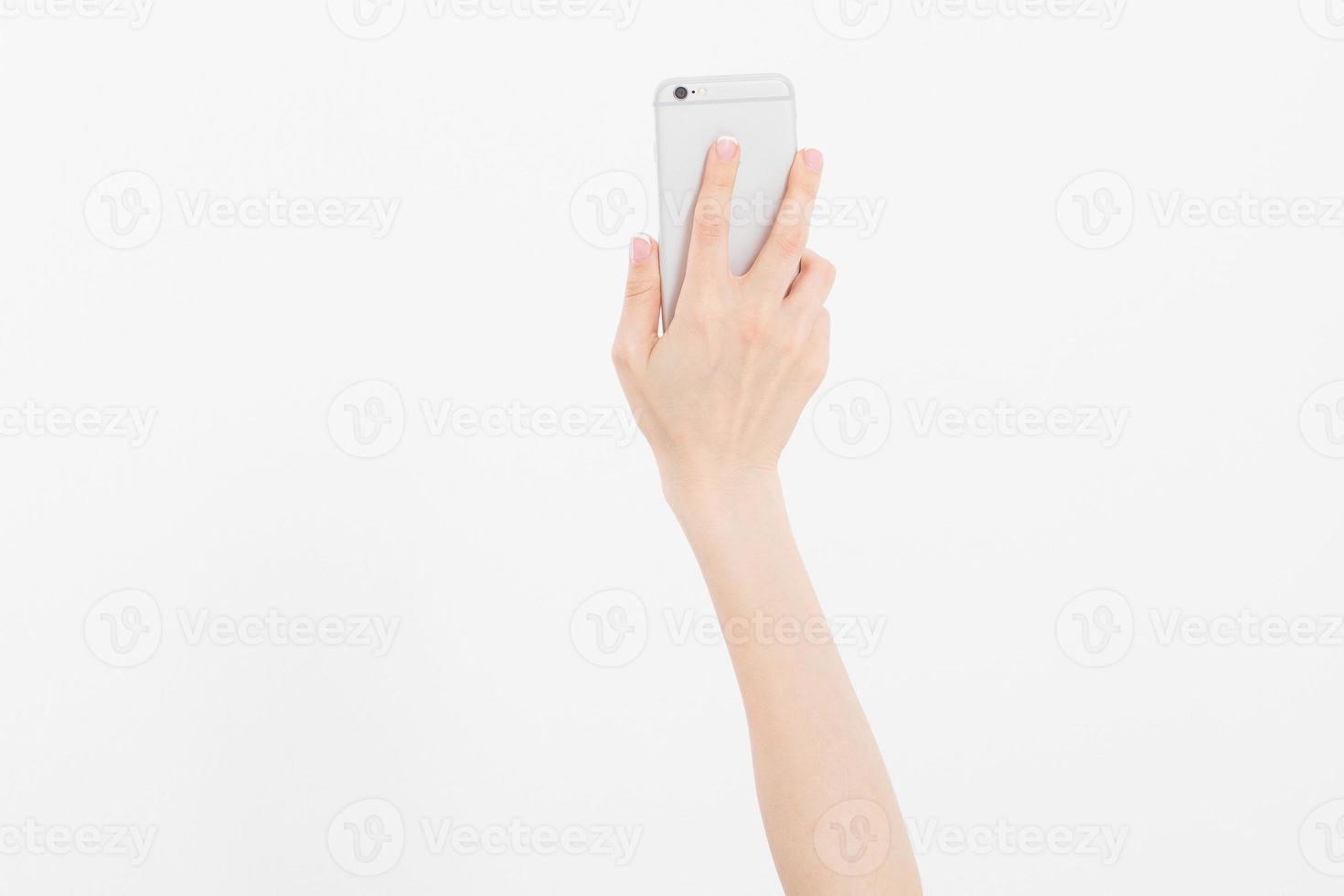 Hand holding white phone isolated on white clipping path inside. Top view.Mock up.Copy space.Template.Blank. photo