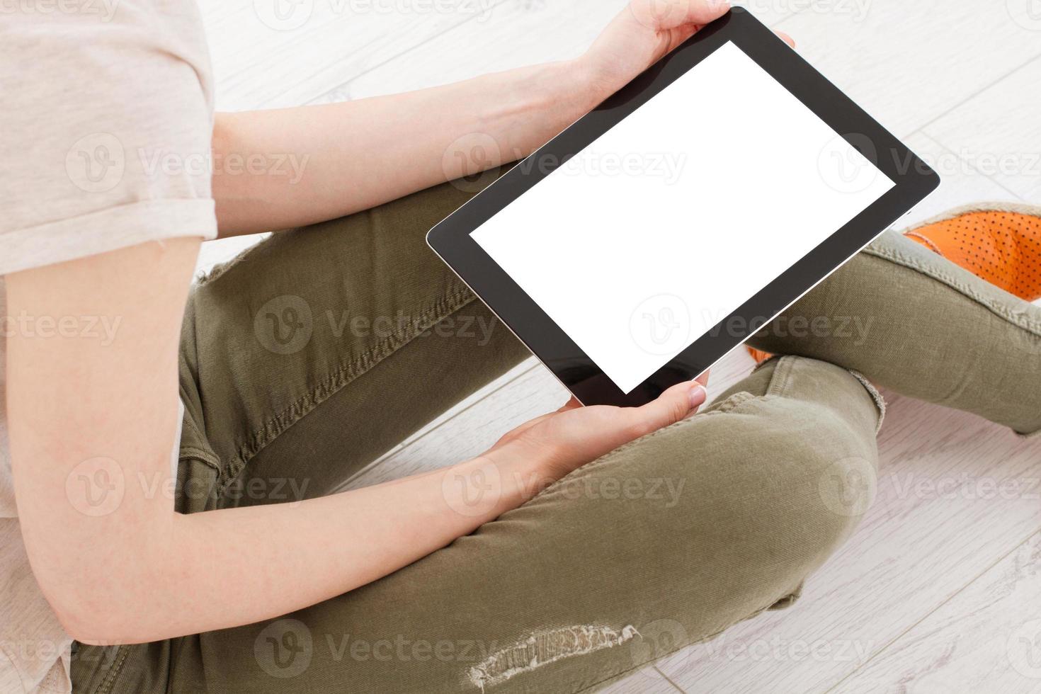 Girl sitting with tablet in hands.Top view.Mock up.Copy space.Template.Blank. photo