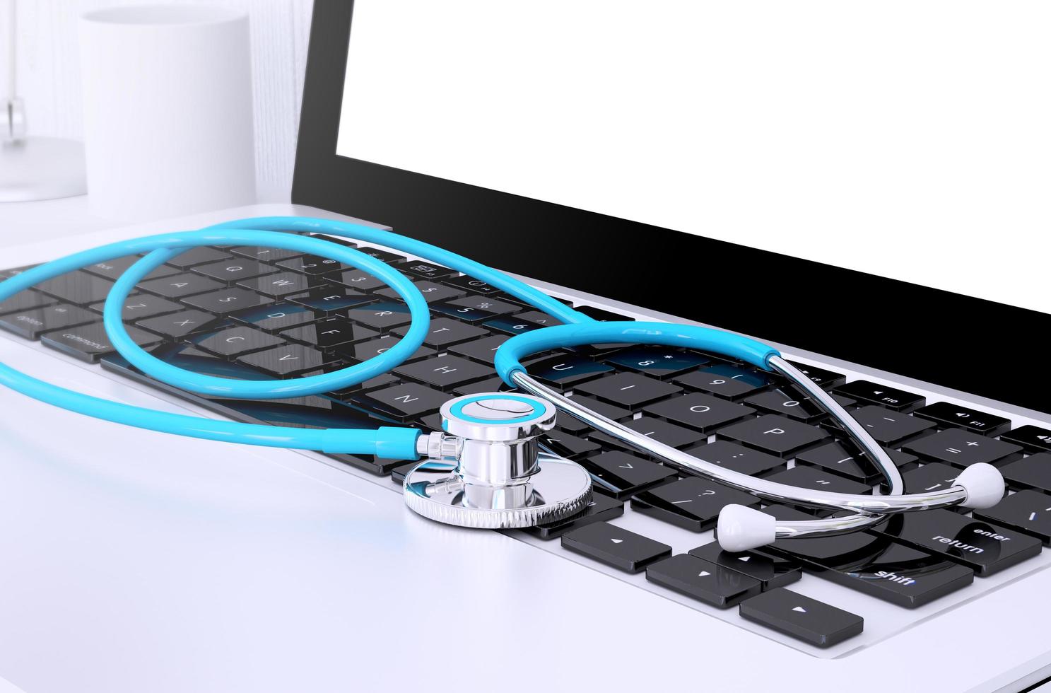stethoscope on laptop keyboard photo