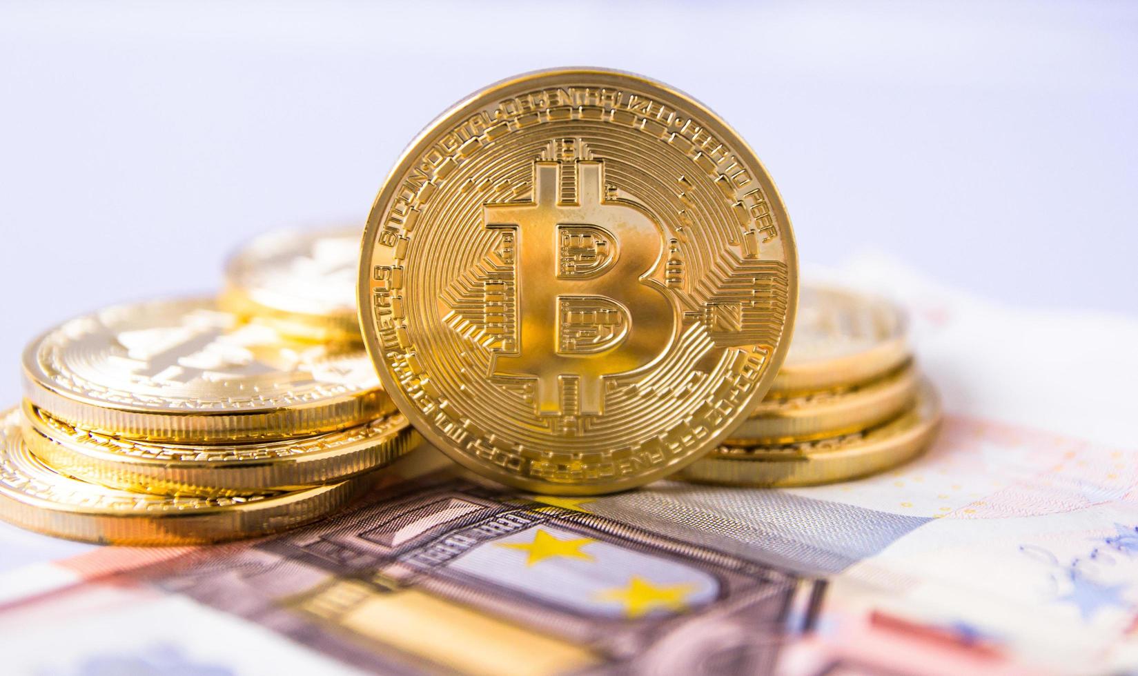 bitcoins over euro bill photo