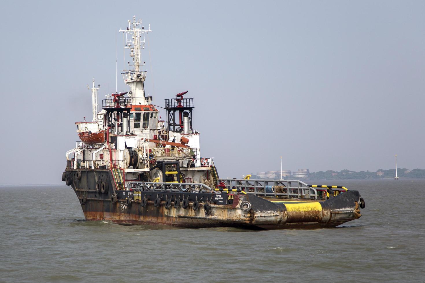 MUMBAI, INDIA, OCTOBER 11, 2015 - Industrial ship in the waters of Mumbai. The port and shipping industry employs many residents directly and indirectly. photo