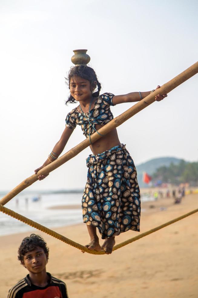 ANJUNA, INDIA, OCTOBER 14, 2015 - Unidentified Goan Girl on a tightrope at the Anjuna Beach. photo