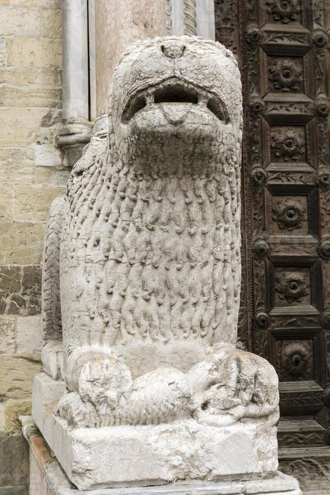 Lion statue in front of Parma Cathedral, Italy photo