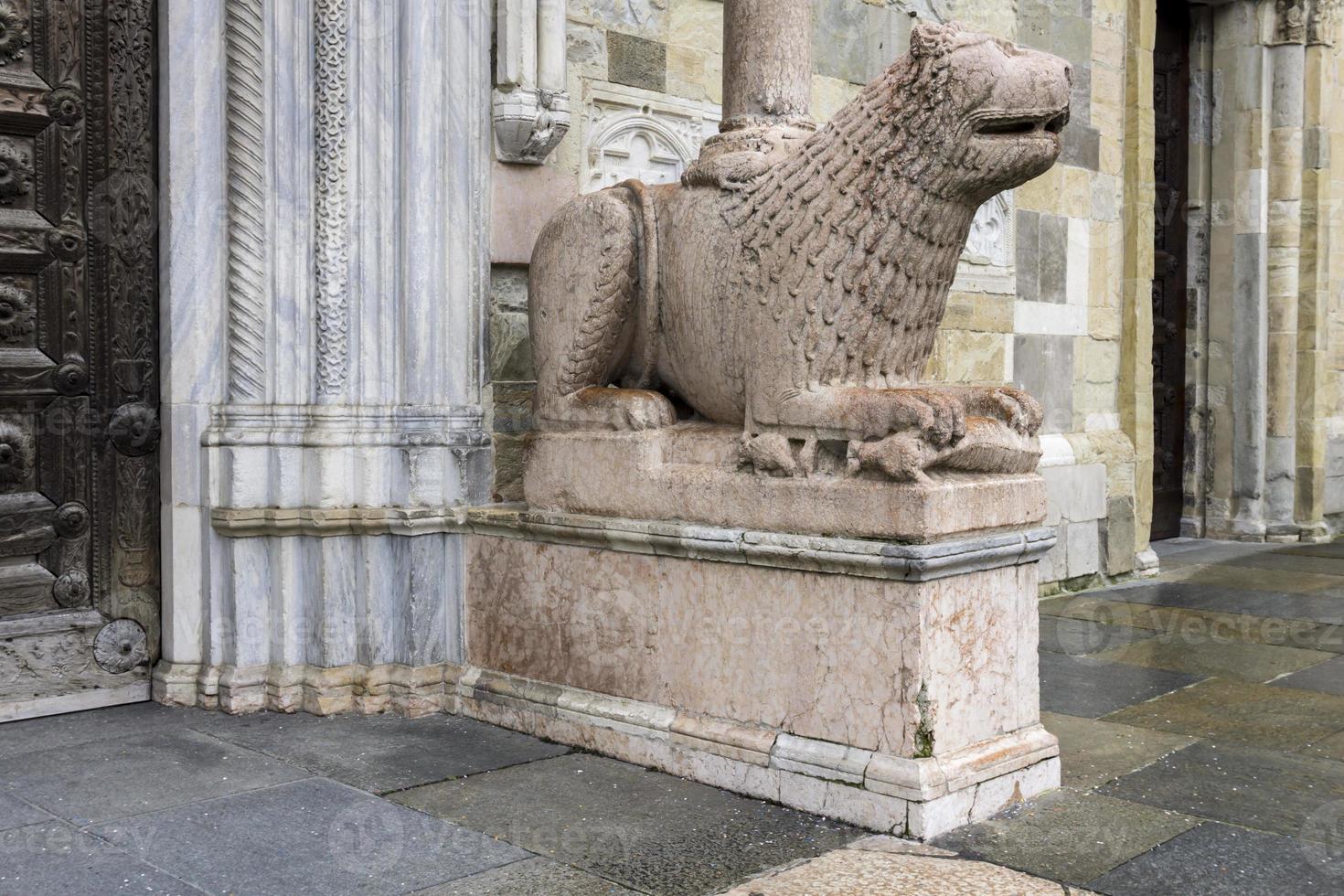 Lion statue in front of Parma Cathedral, Italy photo