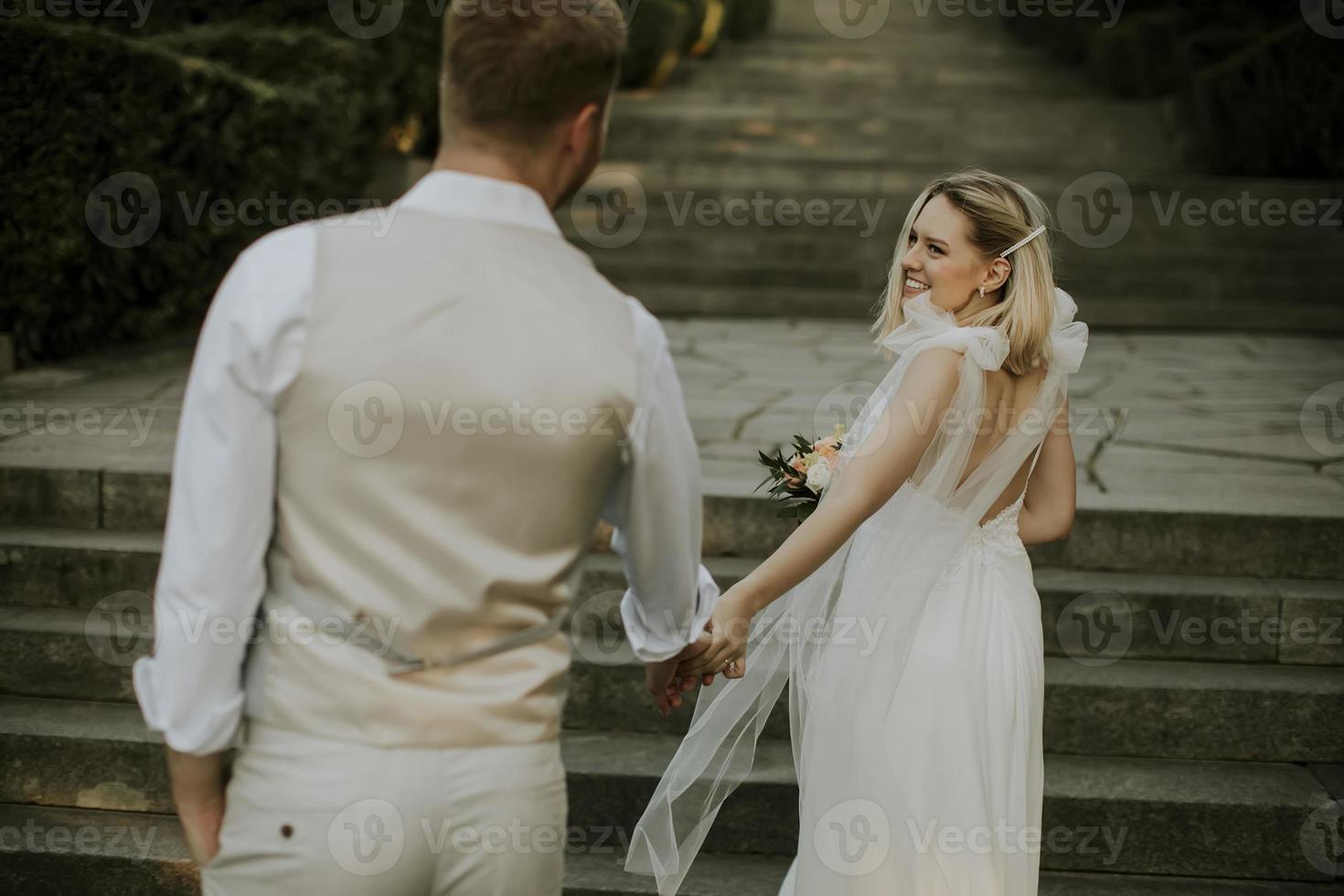 Young newlywed couple walking in the park photo