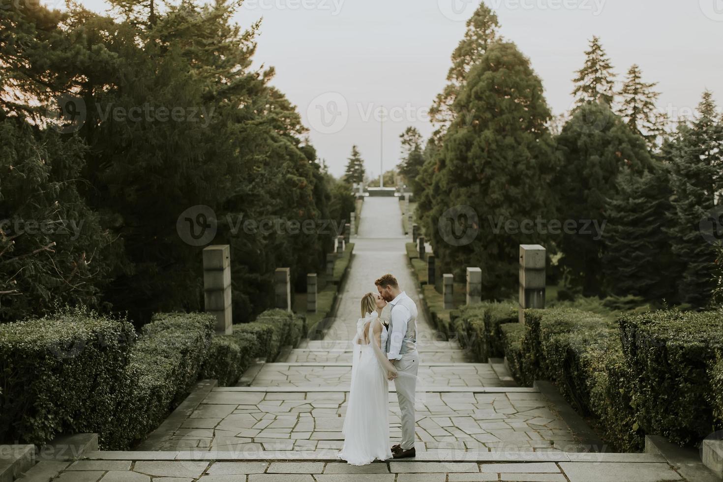 Young newlywed couple walking in the park photo