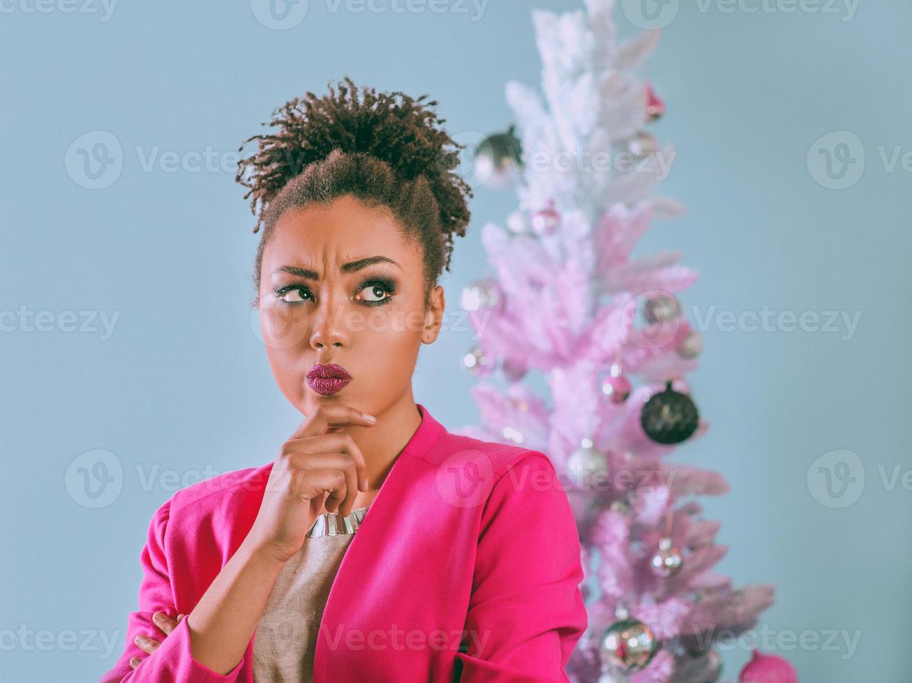 Happy and cheerful afro american woman with present box on the christmas tree background. Christmas, new year, happiness, holidays concept photo