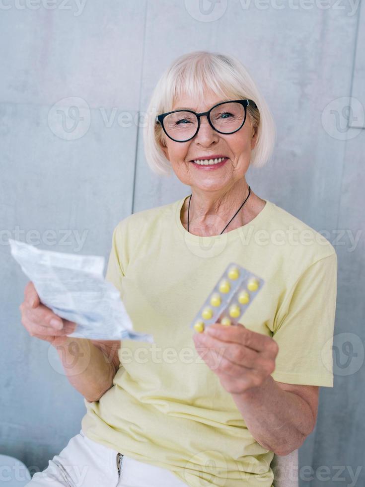 senior woman in glasses reading medicine instruction. Age, health care, treatment concept photo