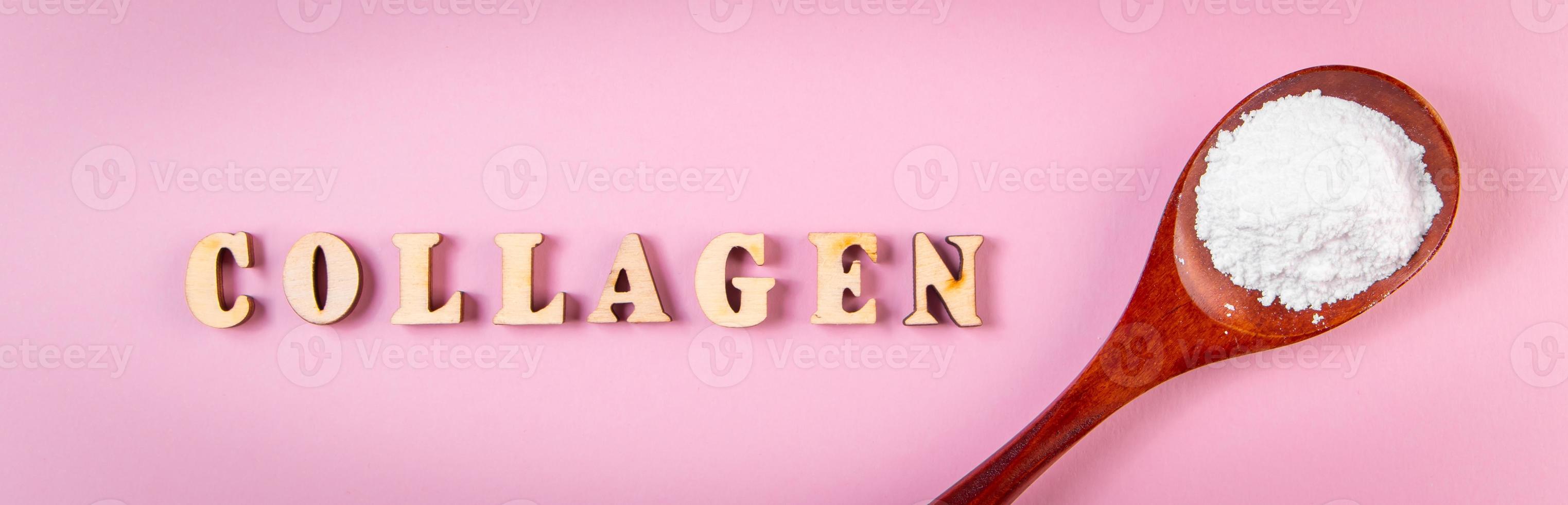 Natural bio supplement collagen powder in wooden spoon on pink background. photo