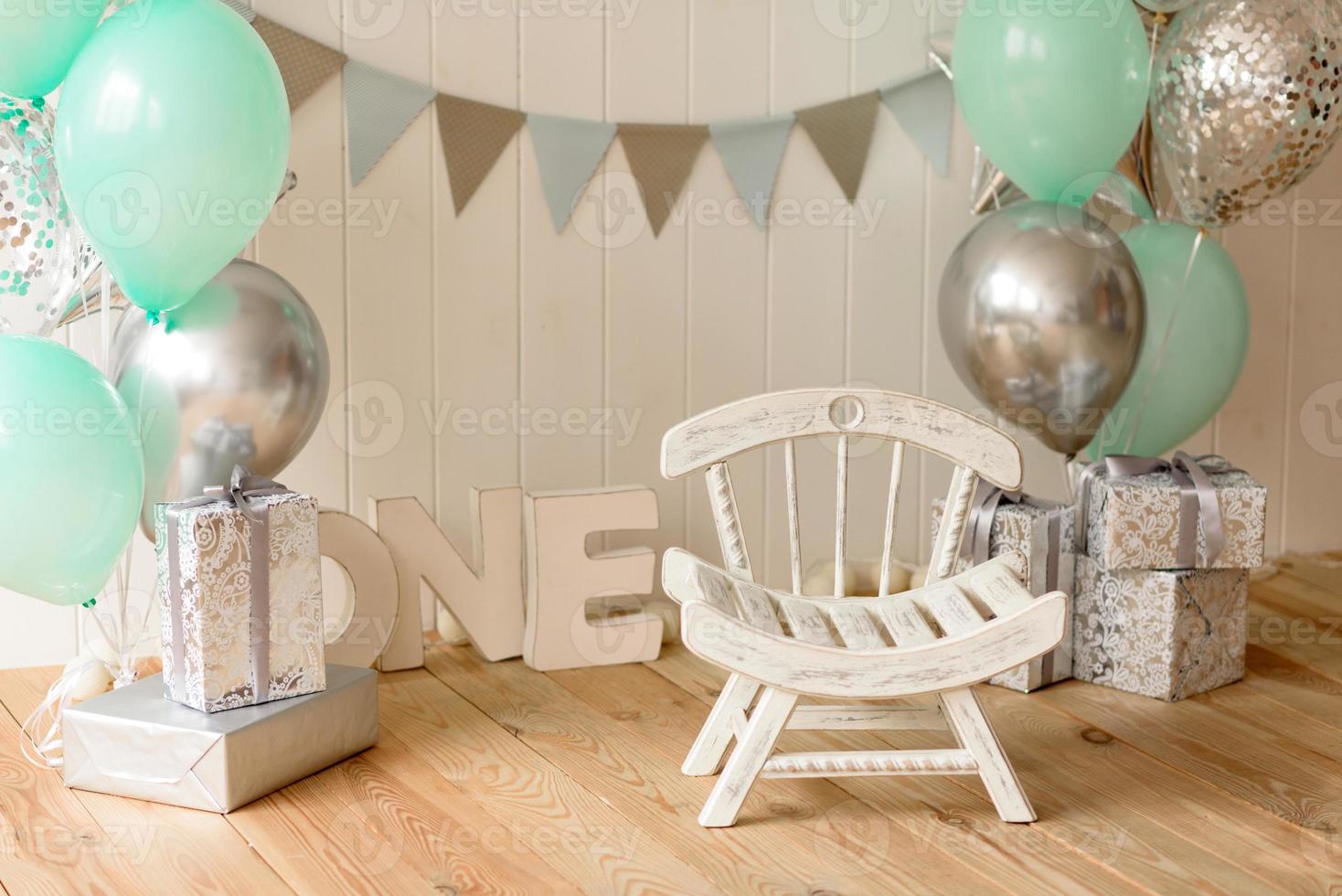 Beautiful interior with white and blue tones, with a chair and letters for one year photo