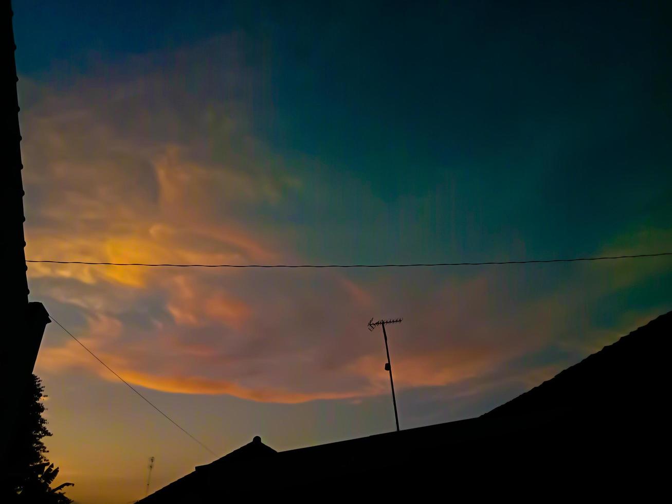 Dramatic sunset sky with clouds. Bright Dramatic Sky And Dark Ground. photo