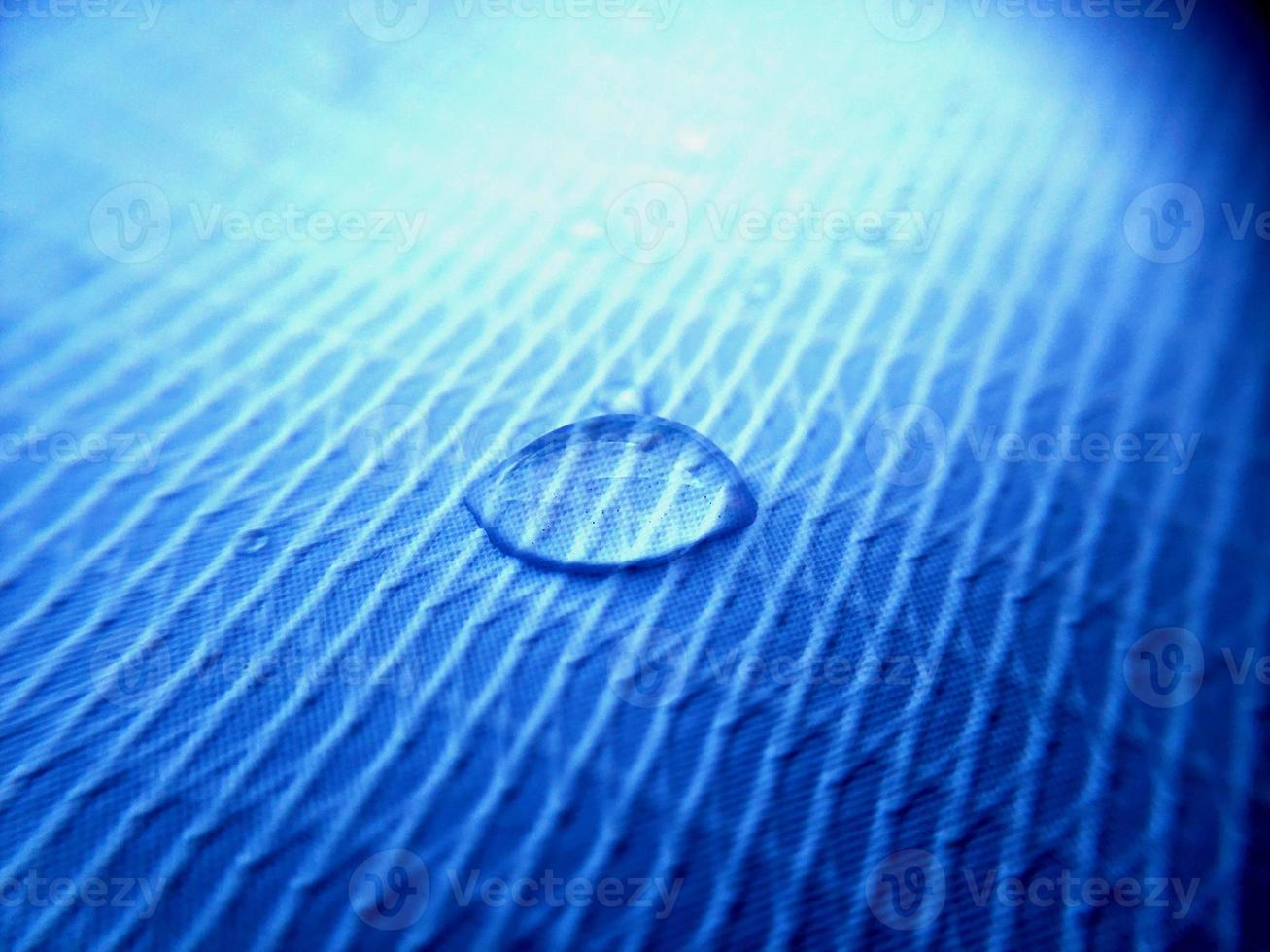 Water drop on fabric textured surface photo