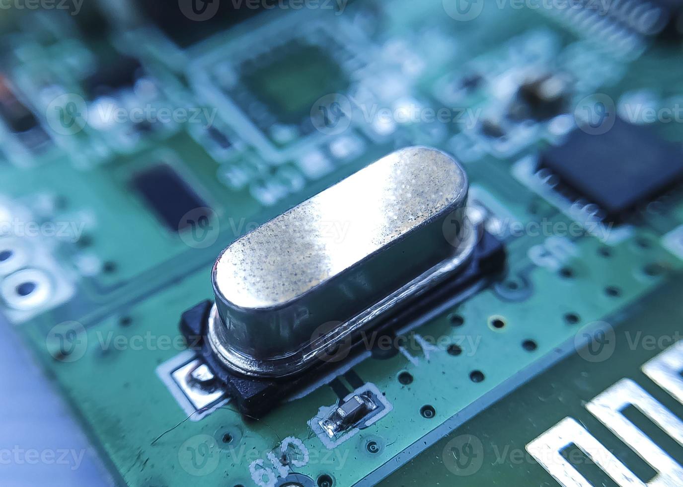 Close up image of crystal oscillator or electronic oscillator circuit. Electronic component. photo