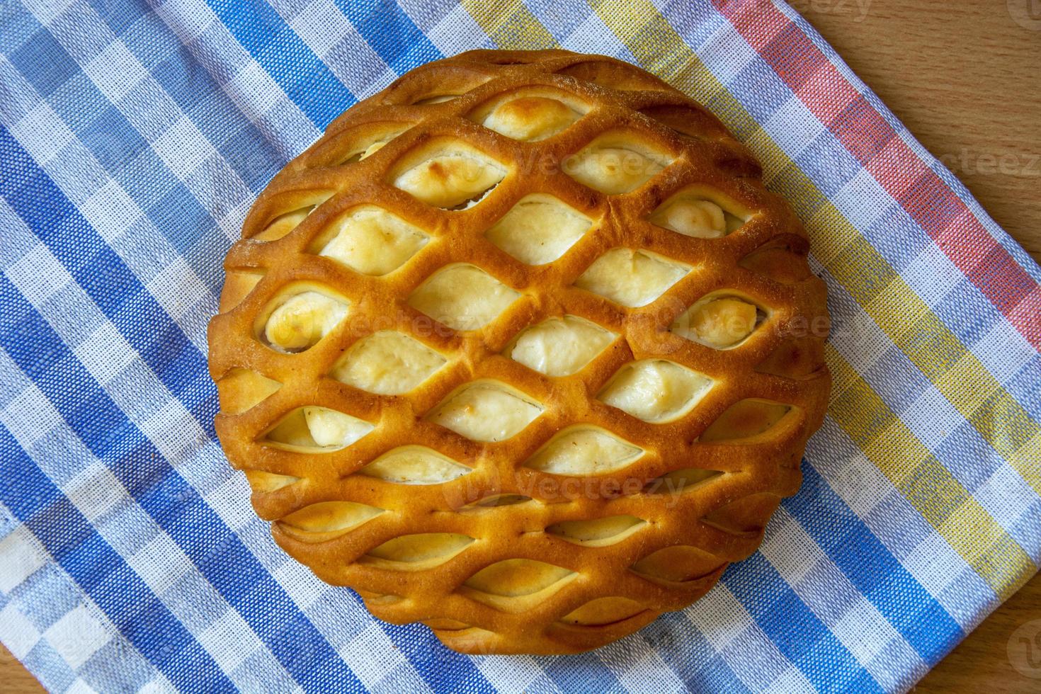 Pastries with curd filling. Bun top view. Easter dessert on a checkered napkin. photo