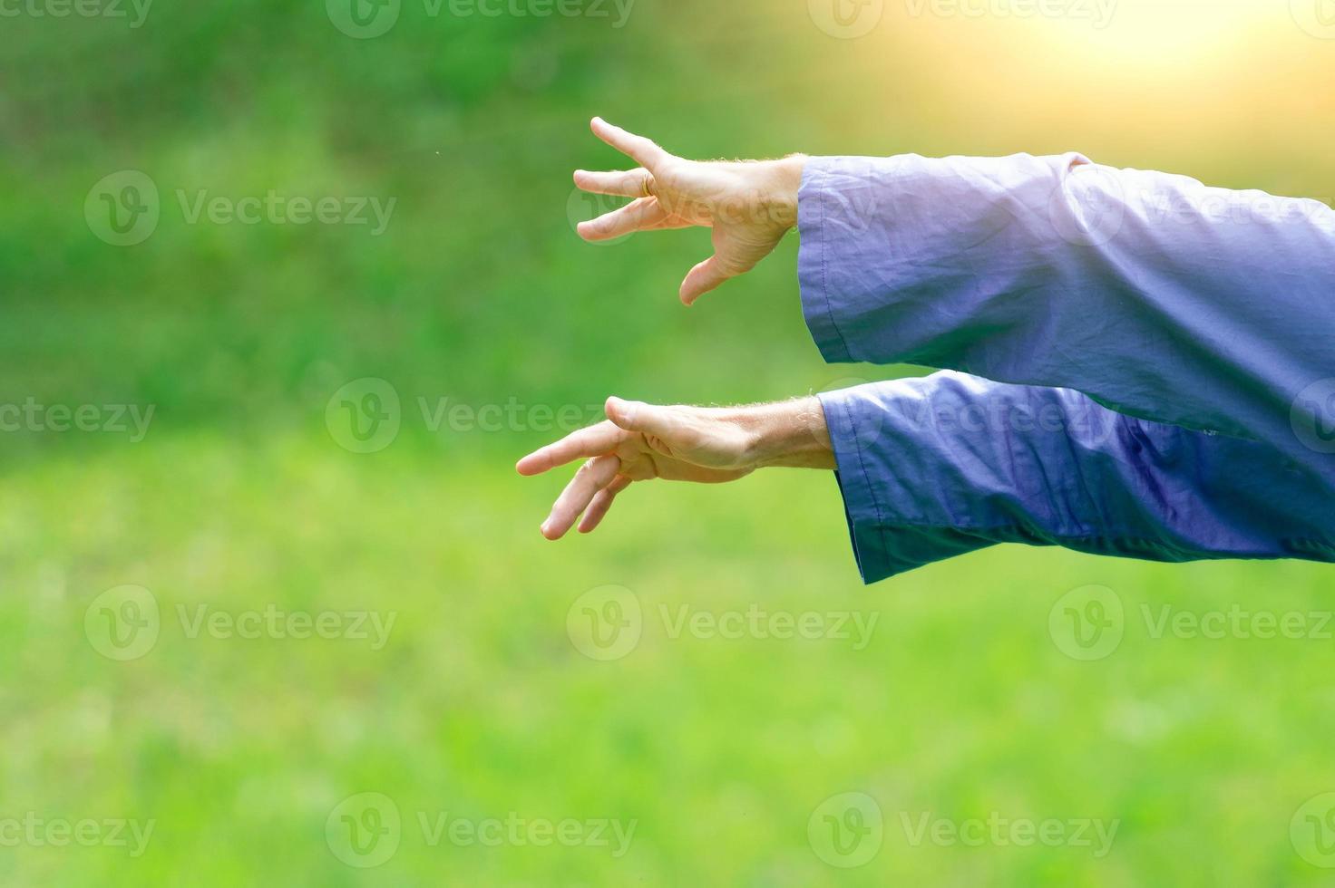 Detail of hand positions of a practicing of Tai Chi Chuan in outdoor. photo