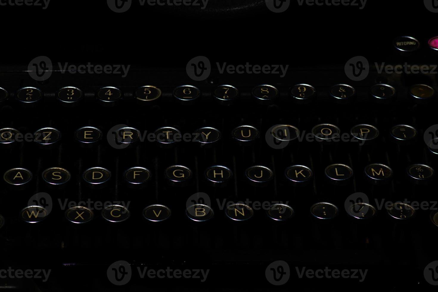 Detail of ancient typewriter on a black background photo