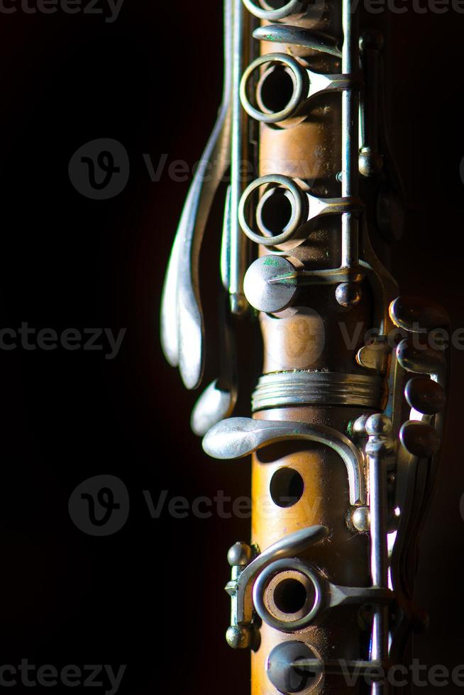 Detail of Antique clarinet on a black background photo