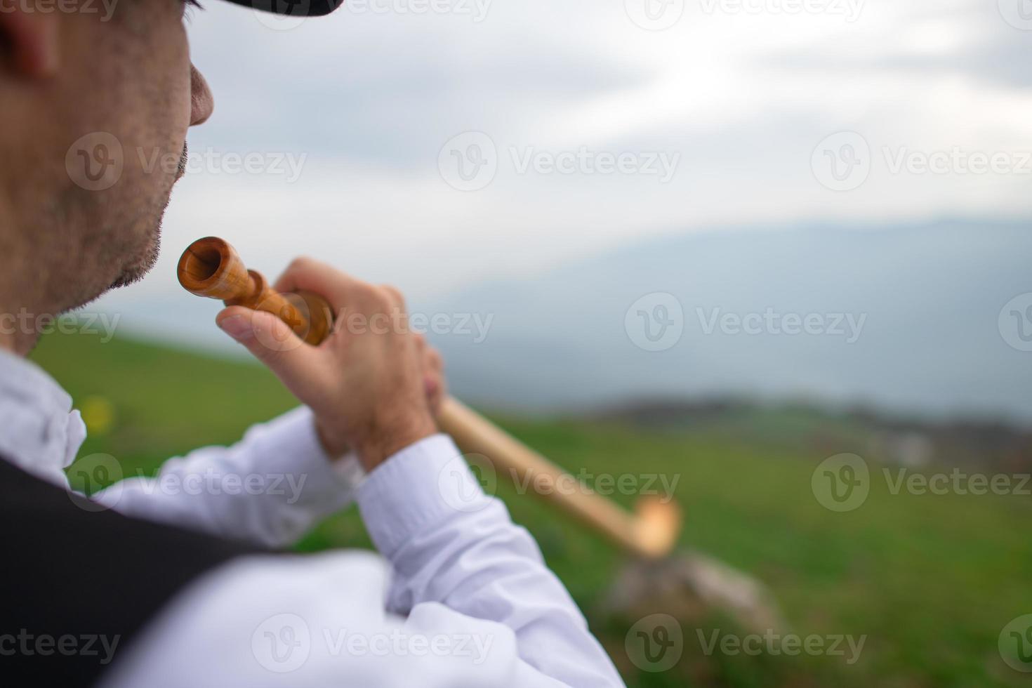 Detail of an Alpine horn player. On the Alps photo