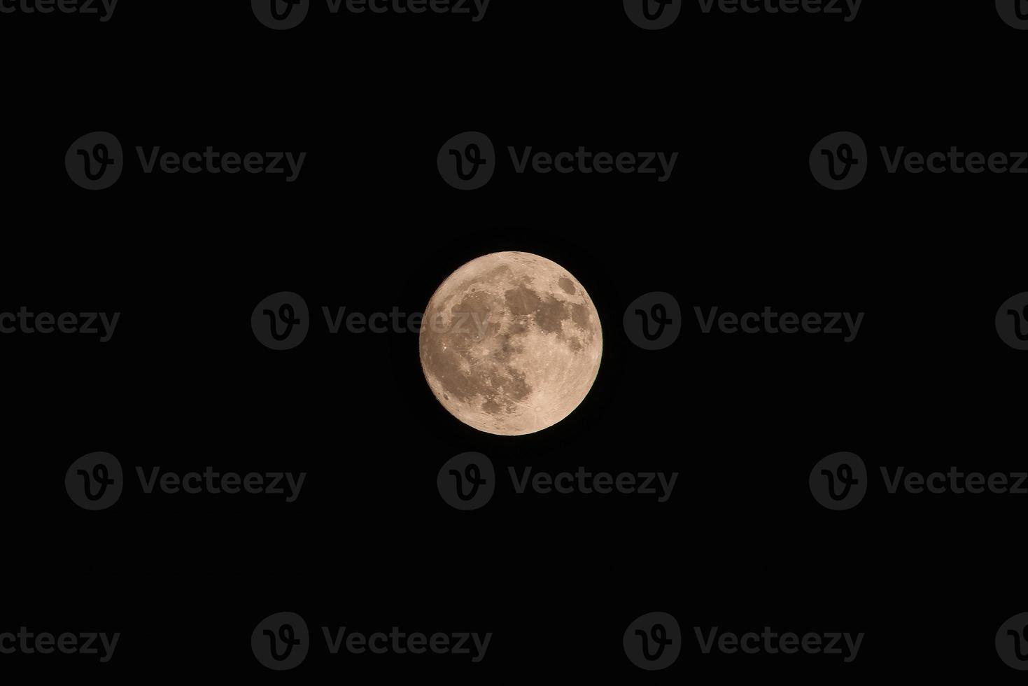 Full yellow moon on dark sky background photo