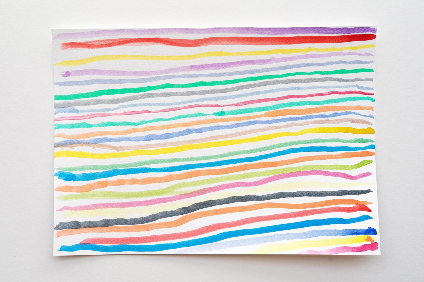 Abstract watercolor lines pattern background. Colorful watercolor painted brush strokes on white paper. photo