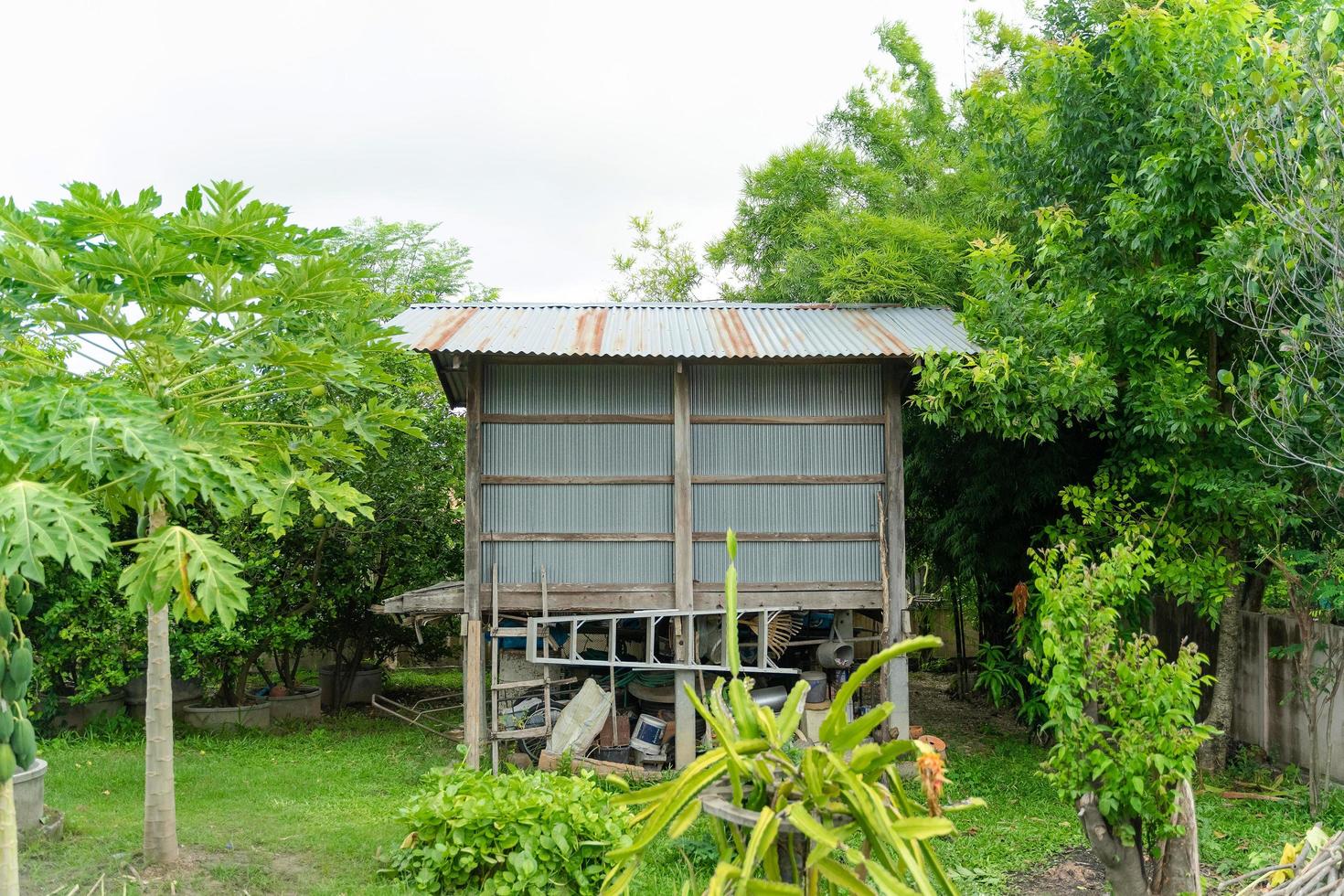 Rice barn for storage and drying of harvested rice in backyard area. photo