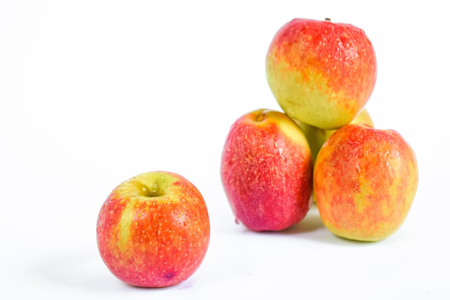 Close-up photo of fresh apples on a white background