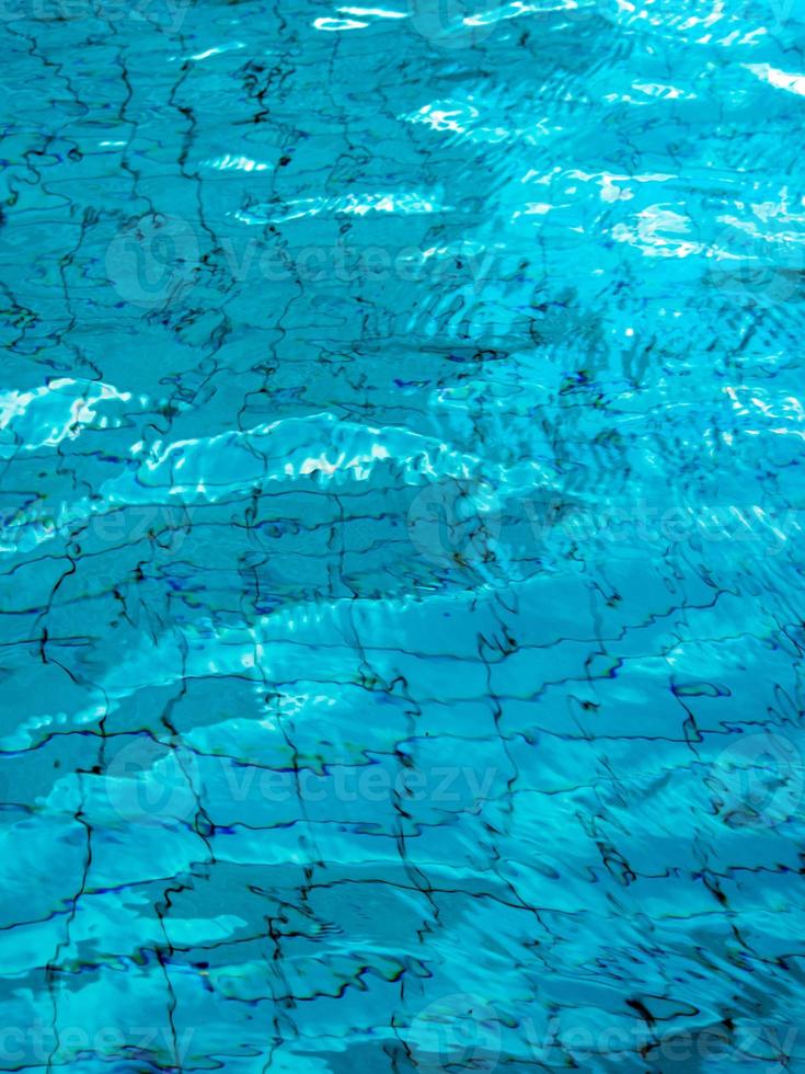 Reflection of sky on the moving water surface in the pool photo