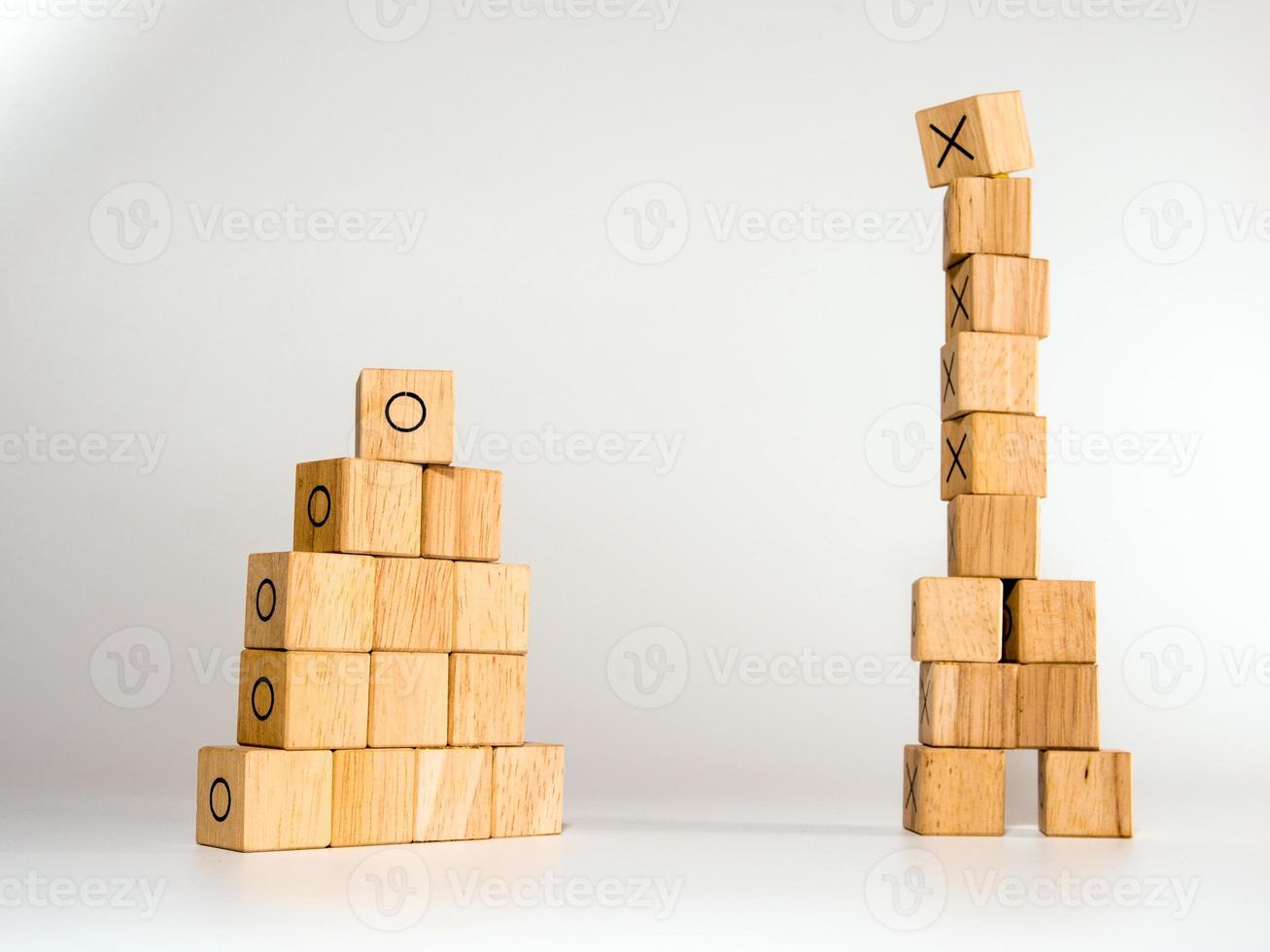 The stacks of rectangular wooden cubes to be two stacks, one high and the other short photo