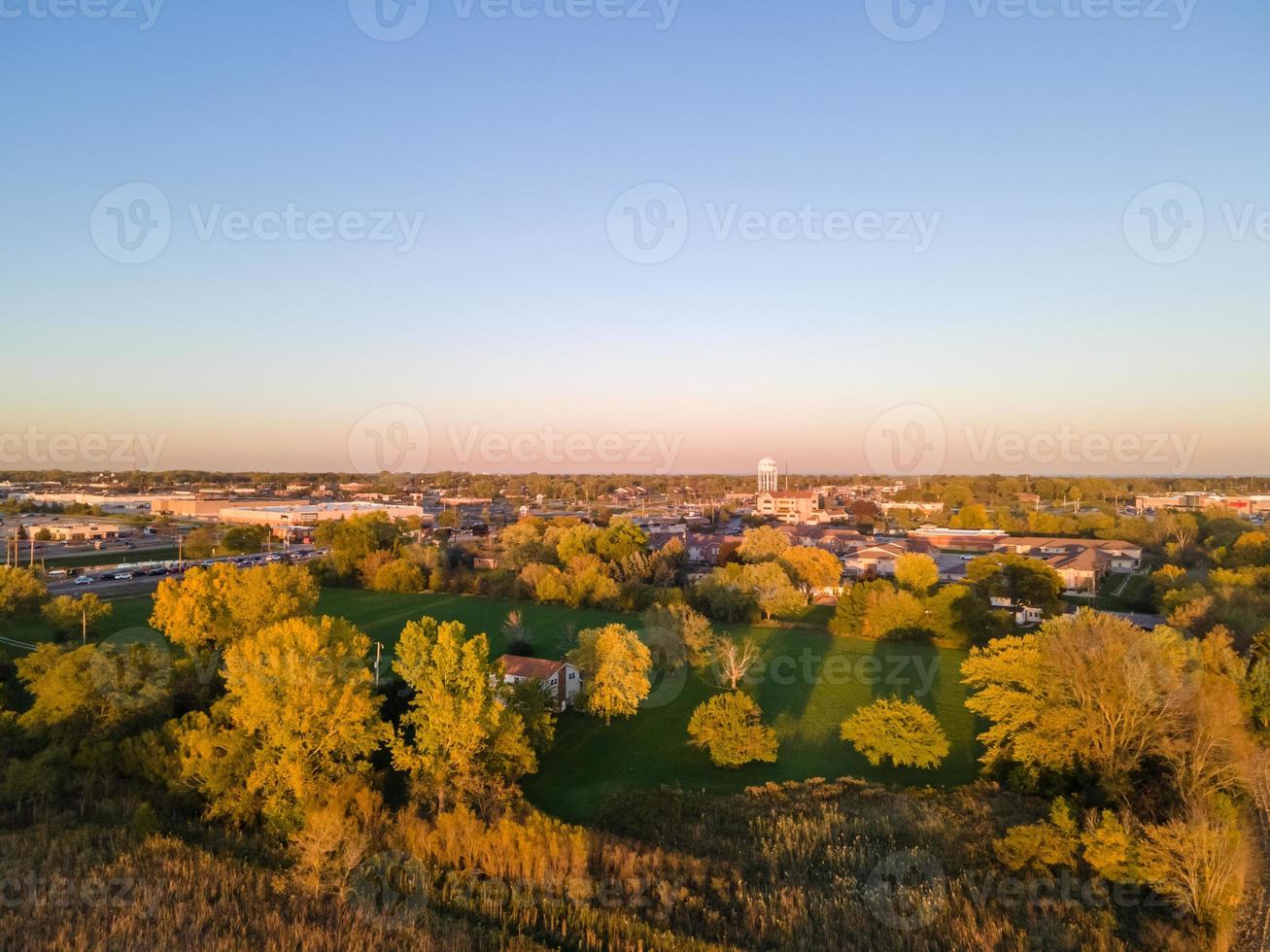 aerial view of residential setting at sunset during autumn with reflections photo