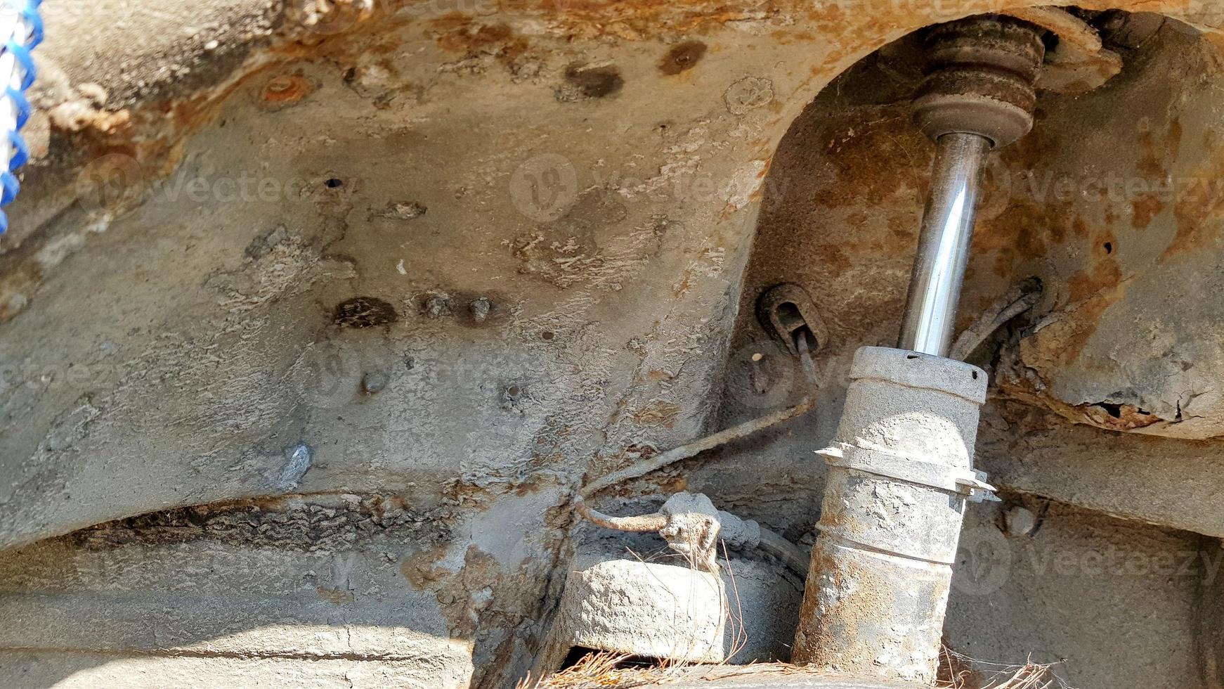 A stand of an old and rusty car closeup. Auto part close-up. A wrecked car at a car service is not subject to restoration and repair photo