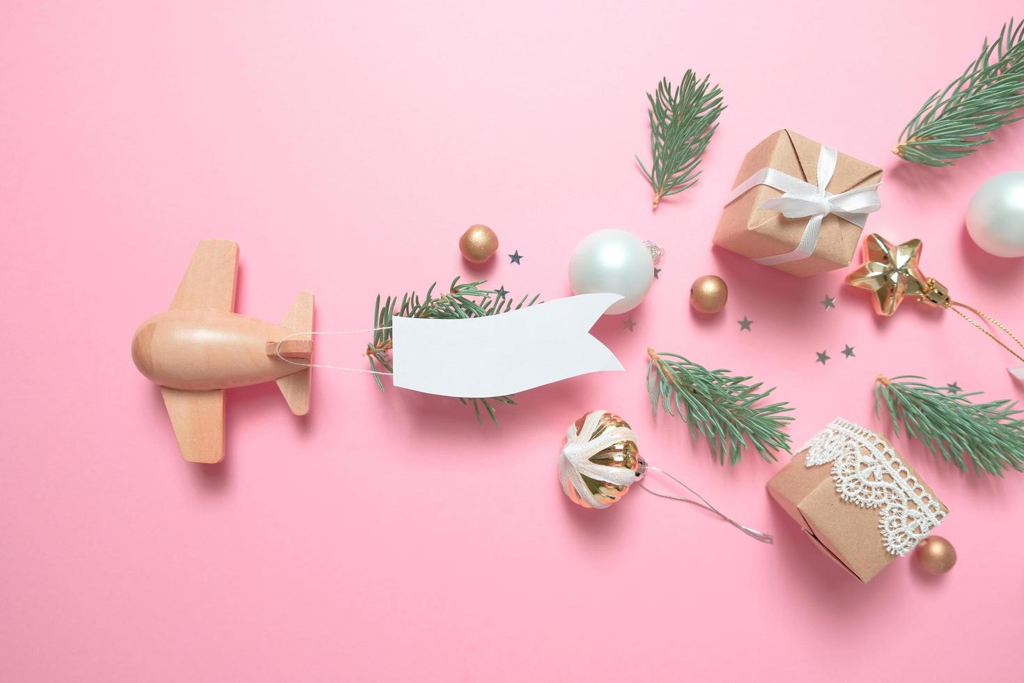 wooden children's plane on a pink background photo