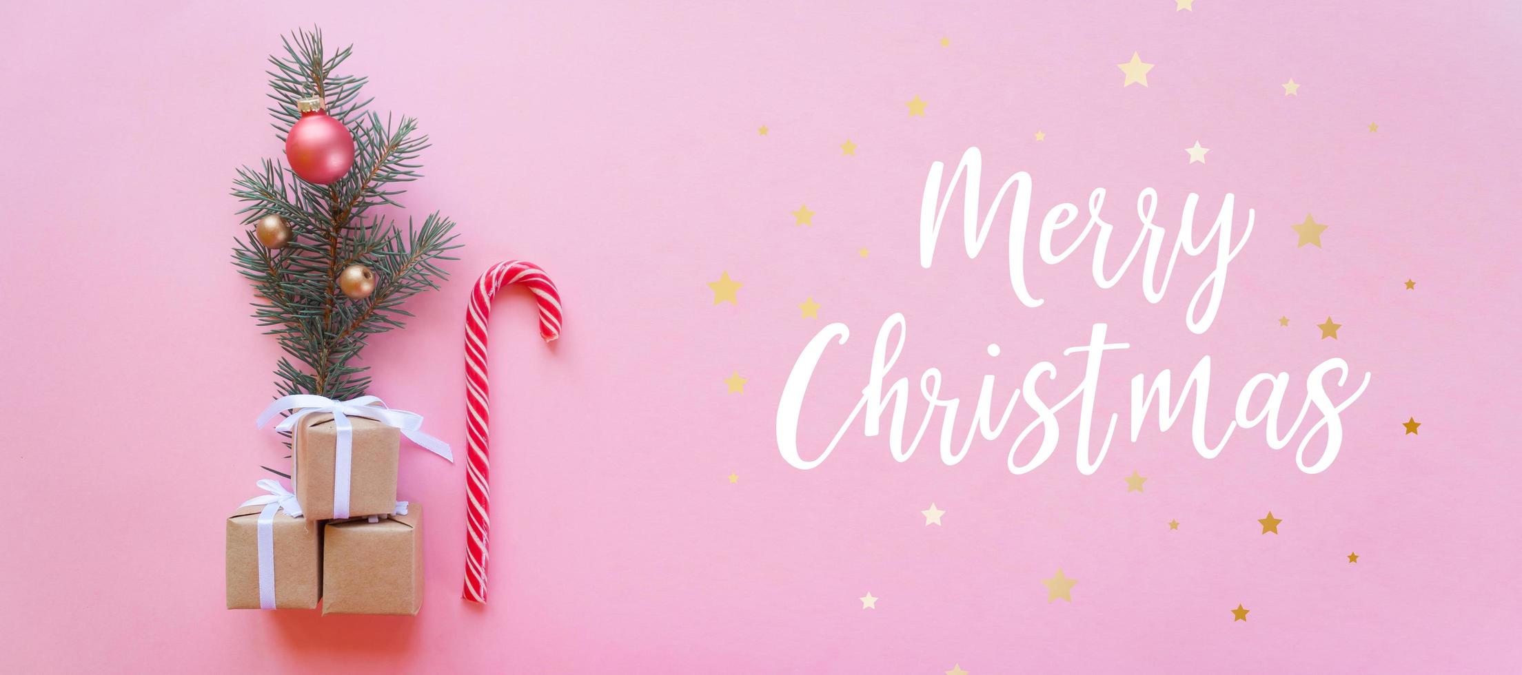 Christmas holidays composition on pink background with lettering Merry Christmas photo