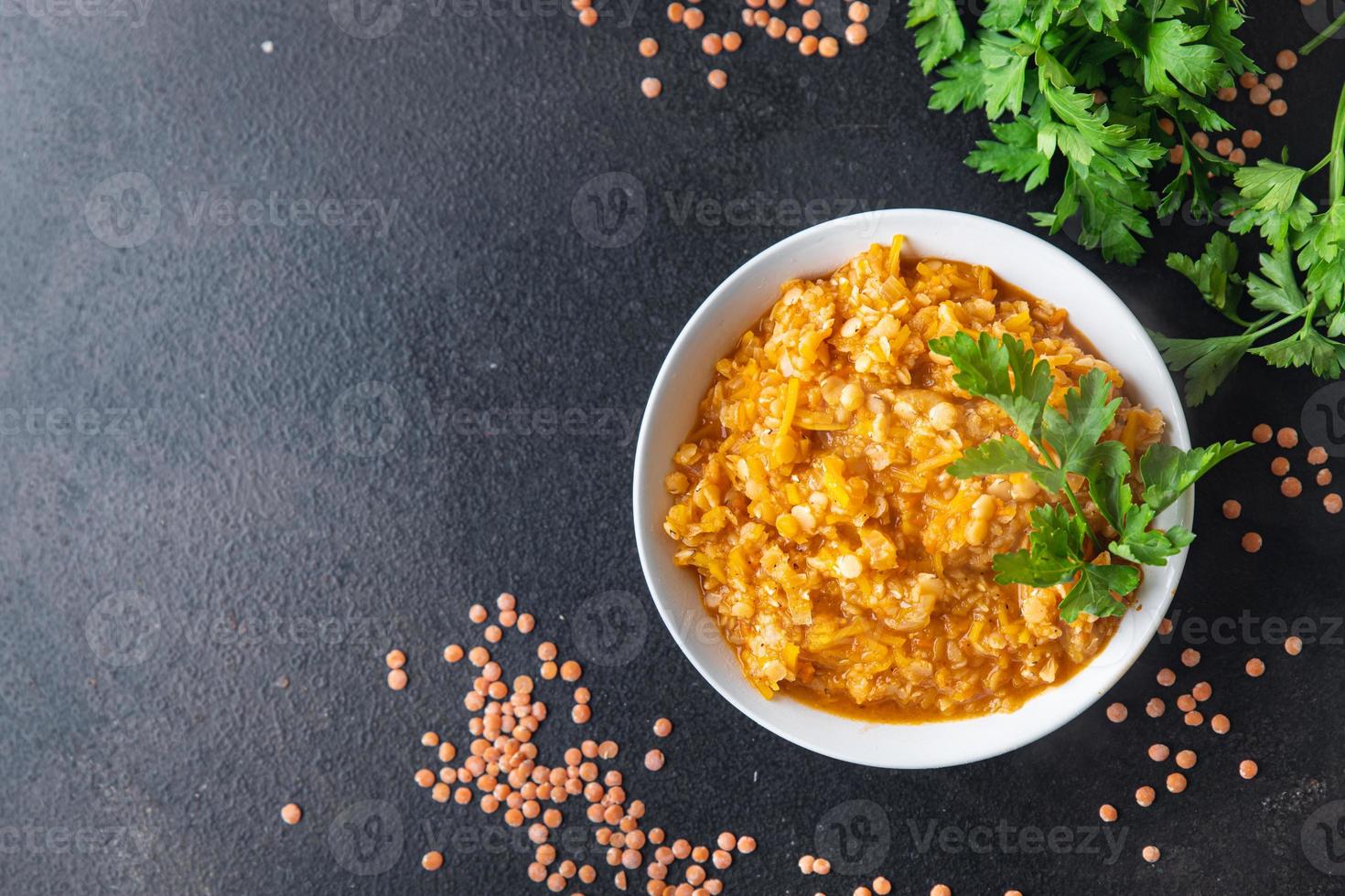 red lentils with vegetables stewed legumes and curry spices indian dal soup photo