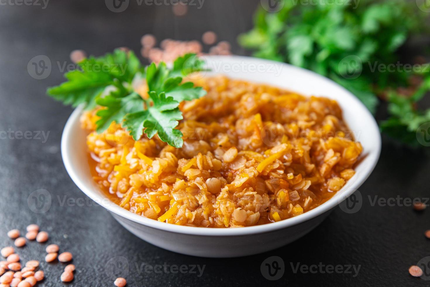 red lentils with vegetables stewed legumes and curry spices indian dal soup photo