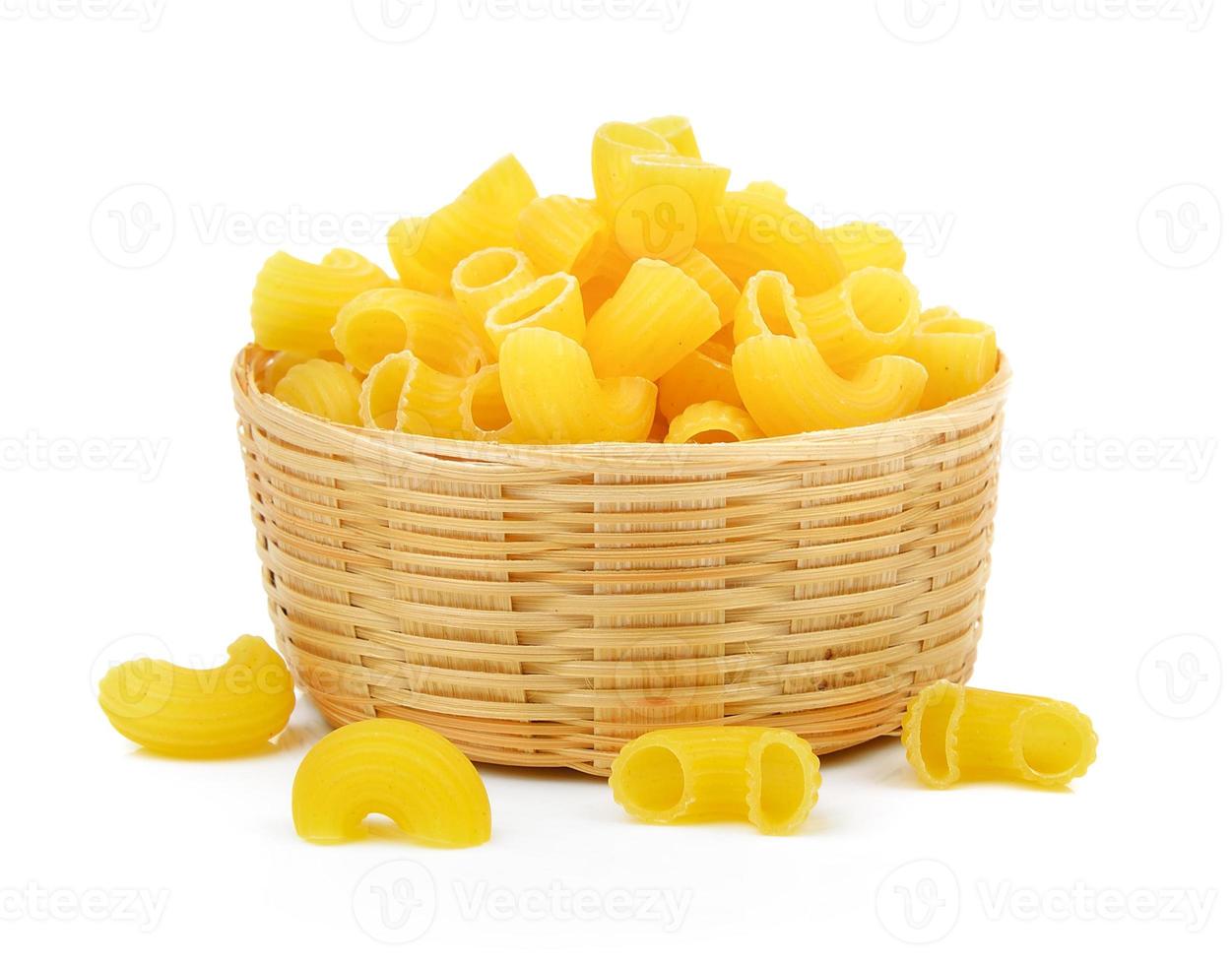 dry macaroni in the basket on white background photo