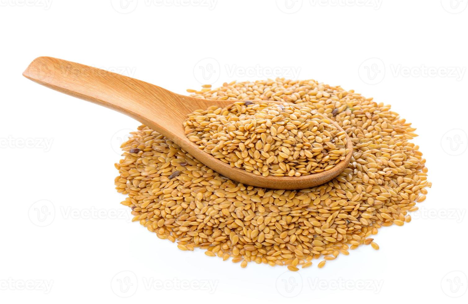 Flax seeds heap in wood spoon isolated on white background photo