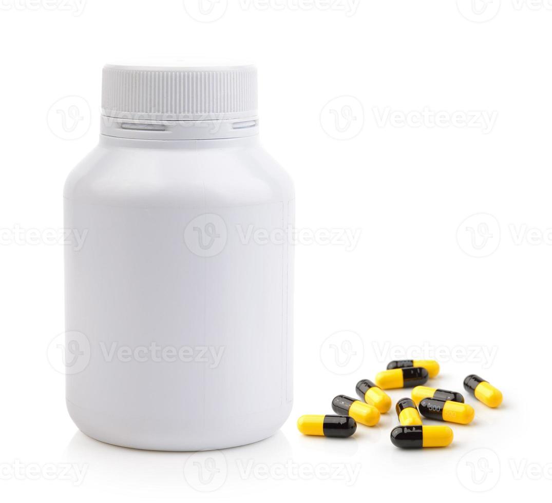 Pills spilling out of pill bottle photo