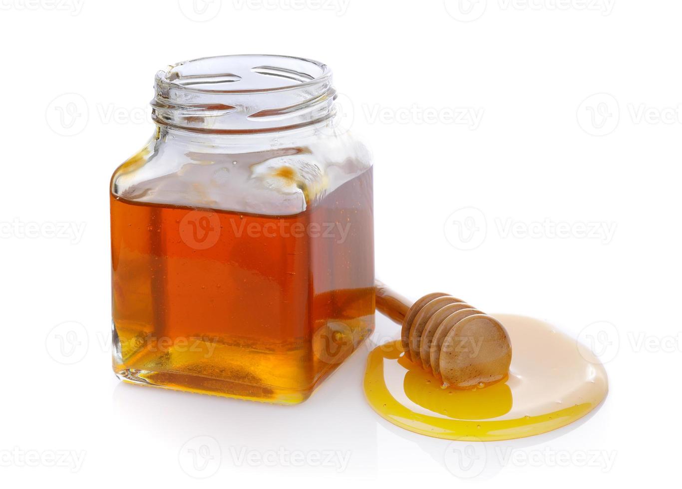 miel con cucharón de miel de madera foto
