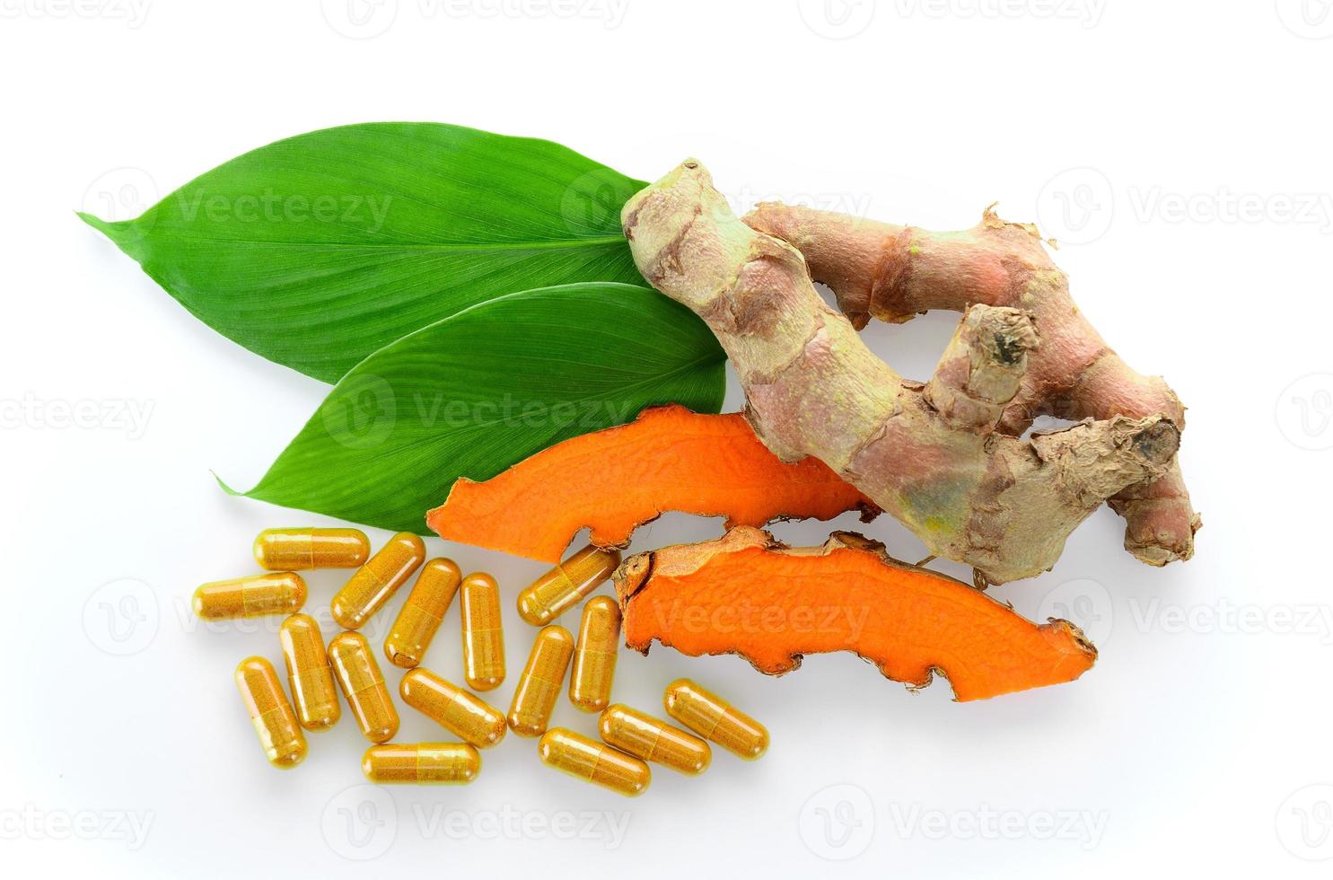 Turmeric and turmeric capsules on white background photo