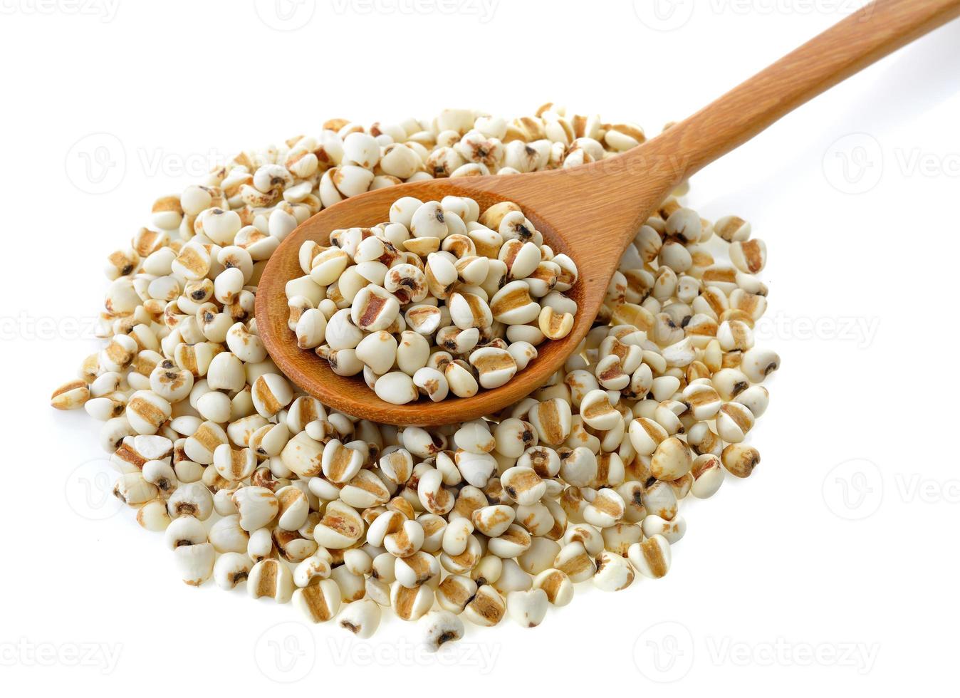 Millet in wood spoon isolated on white background photo