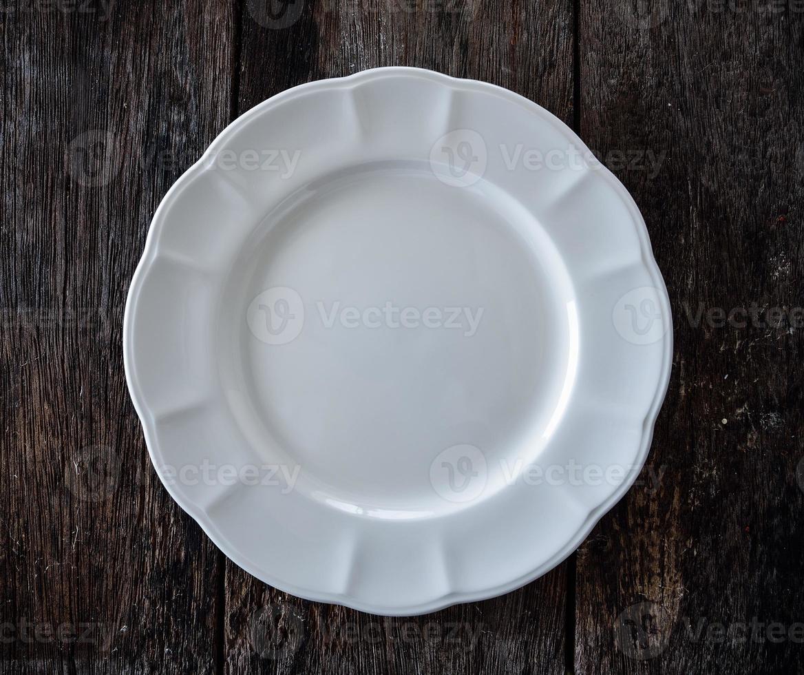 empty white plate on wooden photo