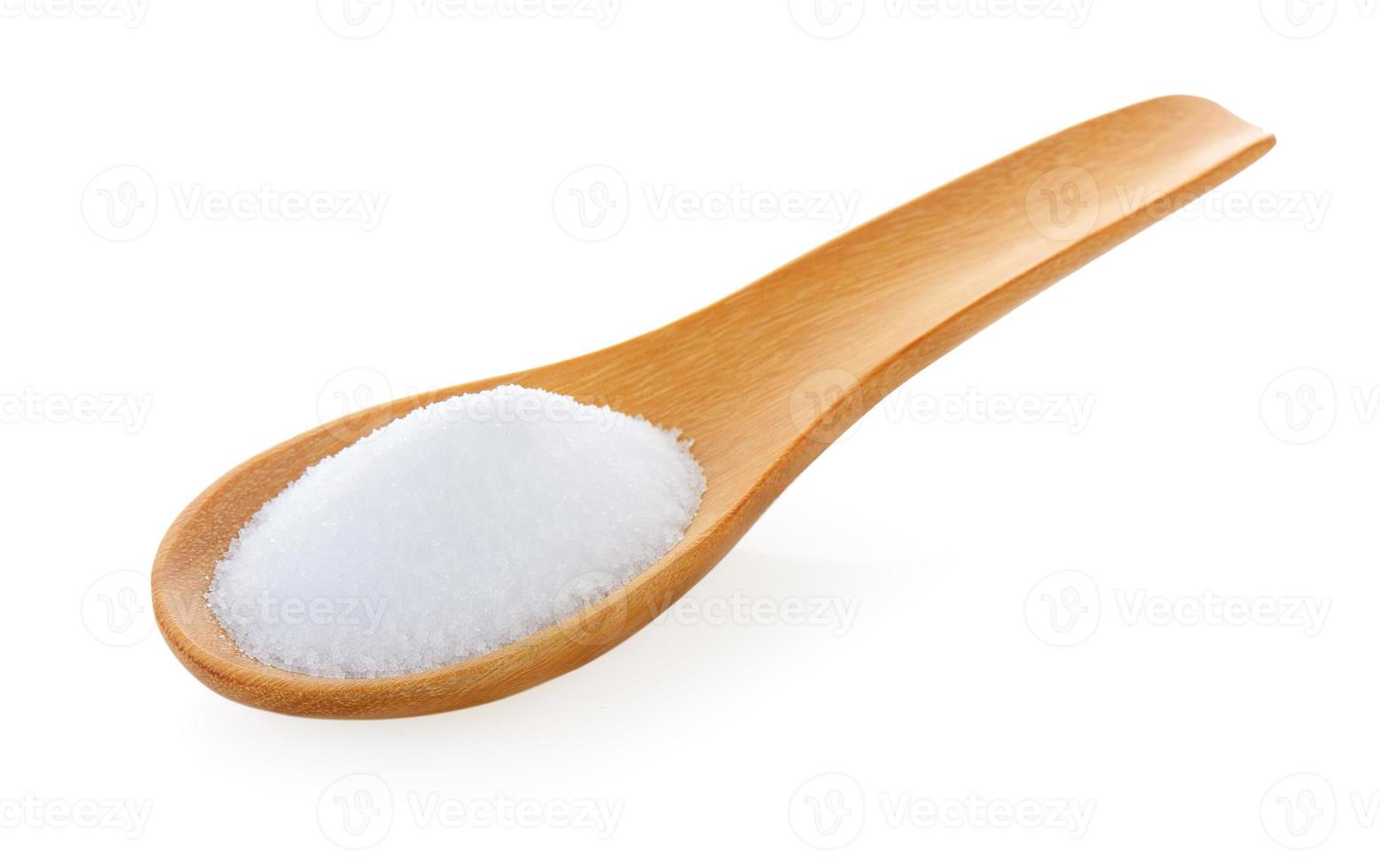Salt in wooden spoon on white background photo