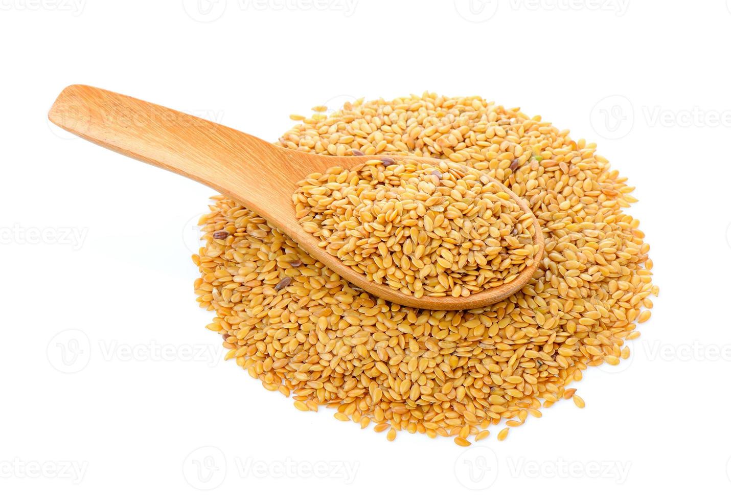 Flax seeds heap in wood spoon isolated on white background photo