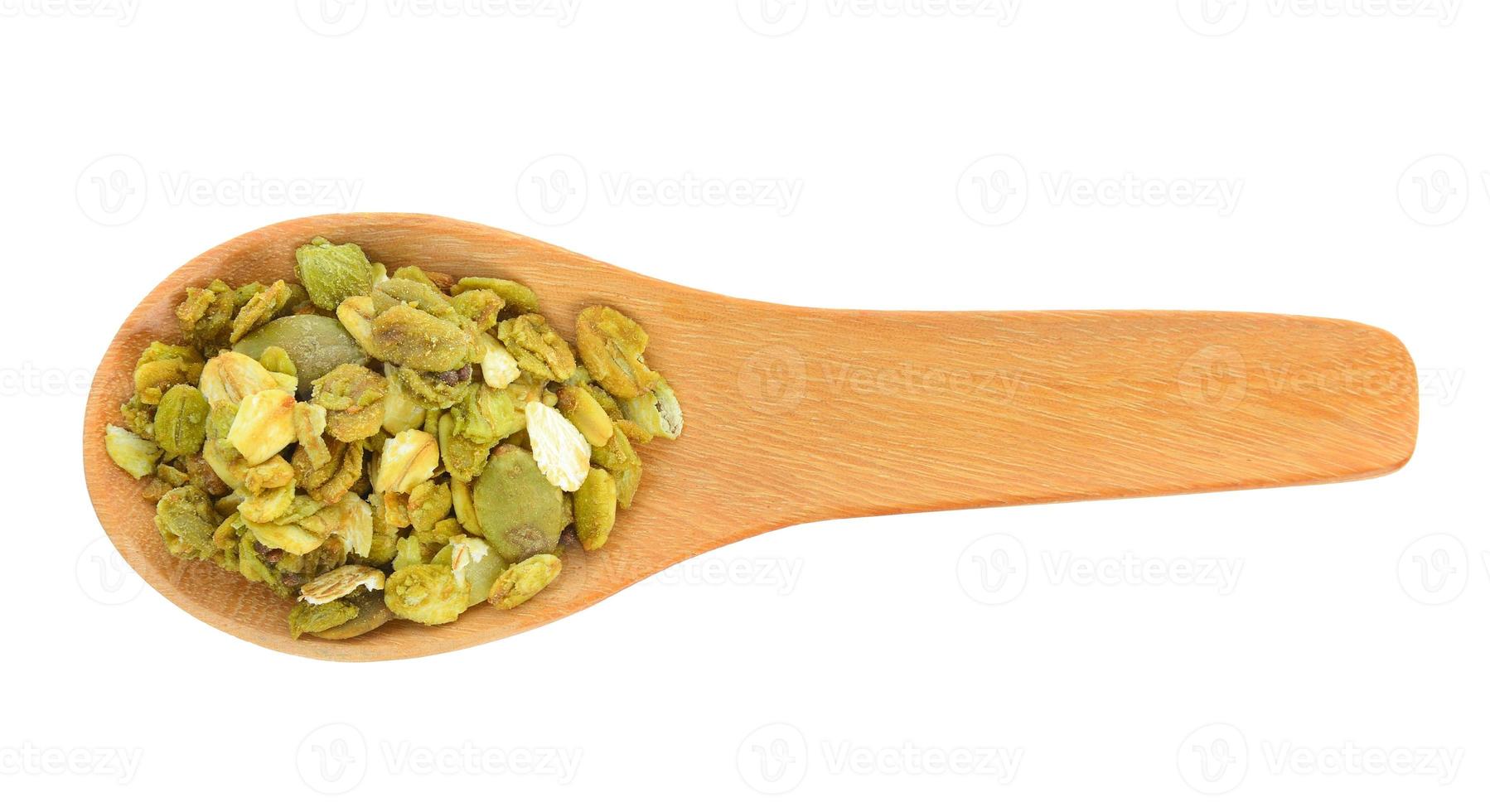 granola cereals in wood spoon isolated on white background. photo