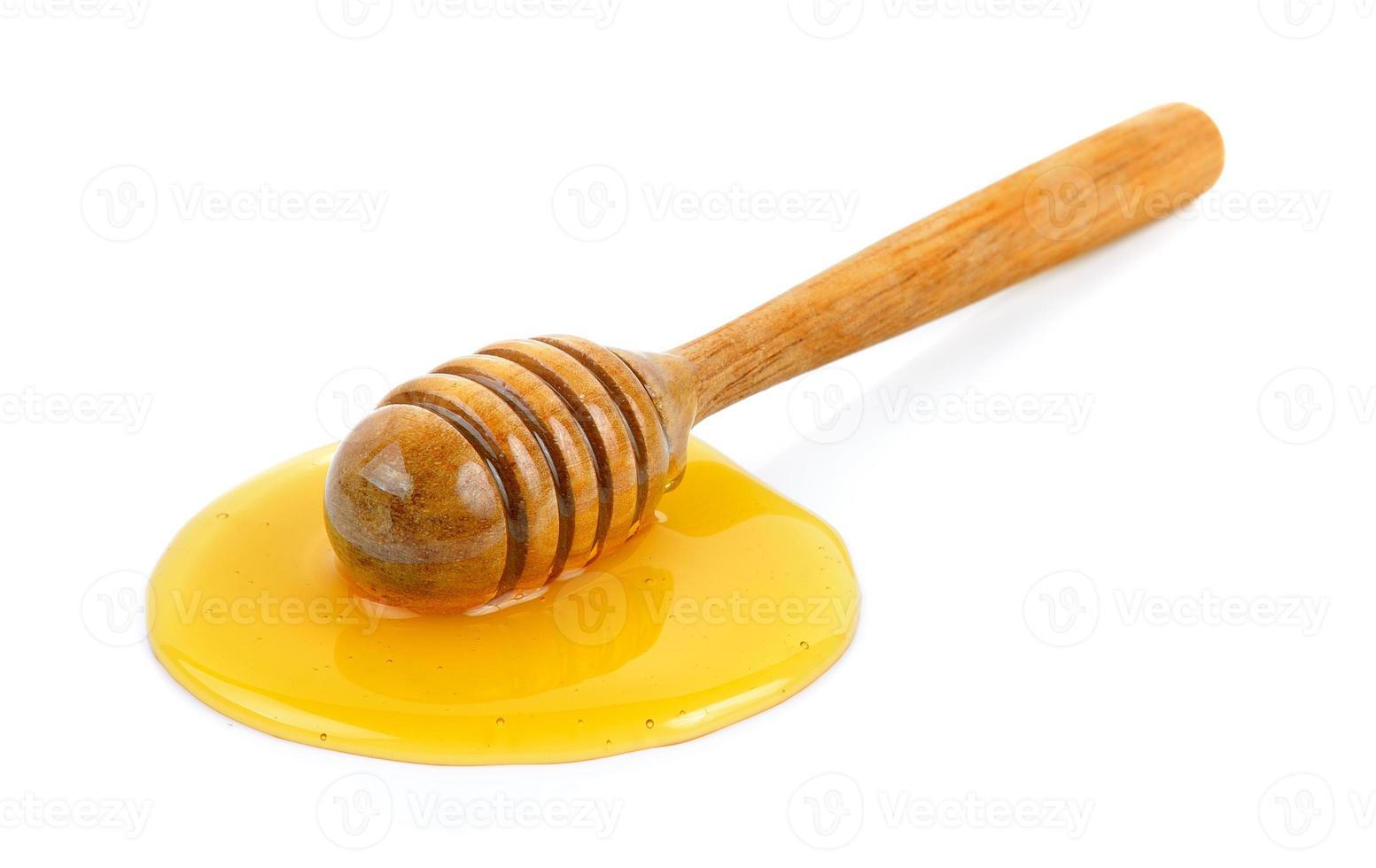 Wooden honey dipper with honey photo