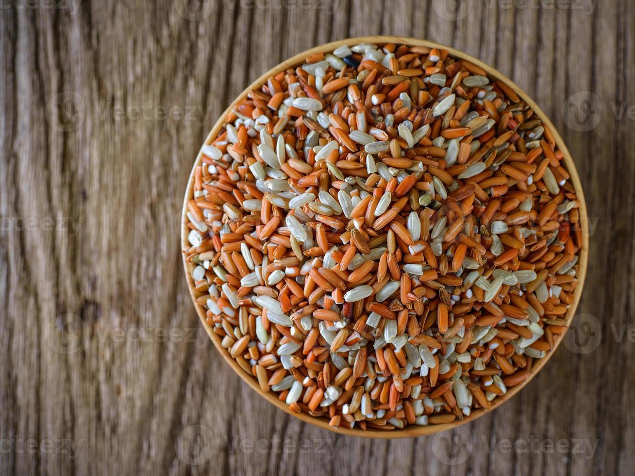 Brown rice seed in bowl. Top view. photo