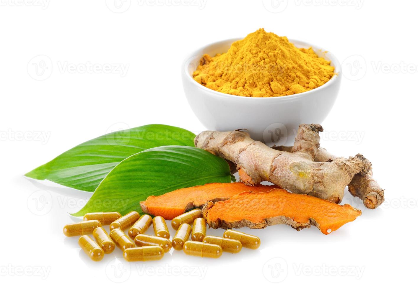Turmeric powder and turmeric capsules on white background photo